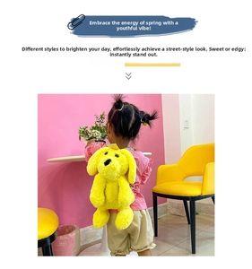 Detail of cute yellow plush dog backpack showing soft texture and puppy facial features