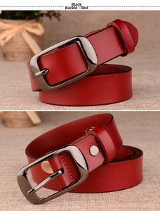 Detail of red genuine leather belt with grainy texture and gunmetal buckle