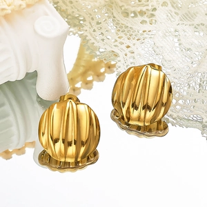 Gros plan détaillé des boucles d'oreilles dorées à motifs sur un miroir élégant