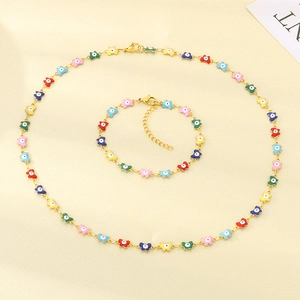 Detail of colorful enamel butterfly necklace and bracelet set with evil eye charms