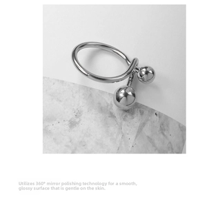 Detailed macro shot of 360-degree mirror polished silver beads on a minimalist ring