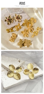 Detail view of gold-plated flower earrings with white pearls and textured metal petals