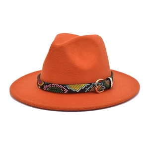 Detail of orange wool fedora featuring a colorful snakeskin band with a golden buckle