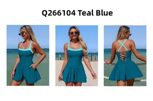 Detail of teal blue one-piece swimsuit featuring a lace-up crisscross back and skirted hem