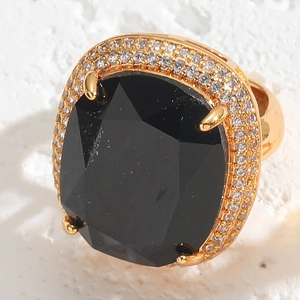 Macro shot of 14K gold-plated ring featuring a large faceted black gemstone with crystal halo