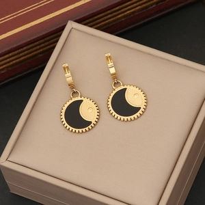 Minimalist gold moon sun pendant earrings in vintage black enamel on jewelry box