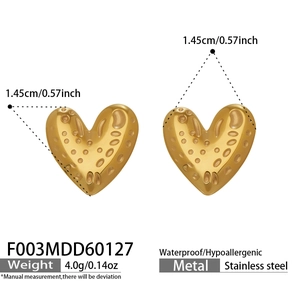 Detailed view of golden heart stud earrings with hammered texture in stainless steel