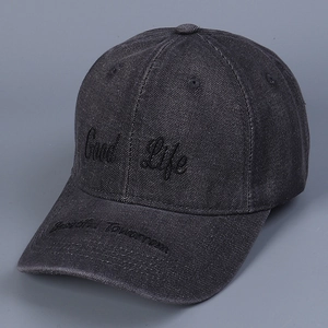 Detail of embroidered Good Life text on dark gray washed denim baseball cap fabric