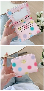 Inside view of pink polka dot wallet showing card slots and zipper compartment