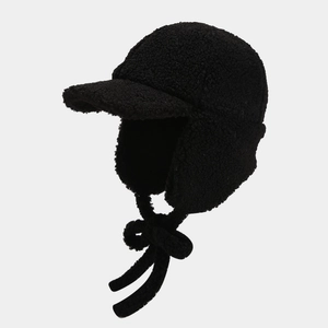 Detail of black sherpa fleece trapper hat with warm ear flaps and adjustable long straps