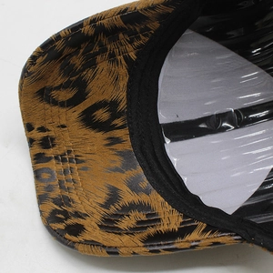 Detailed macro view of the leopard print pattern and fabric texture on a baseball cap