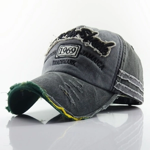 Close-up of distressed brim on vintage washed cotton baseball cap with JAMAICA embroidery