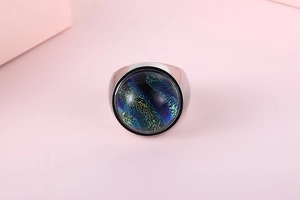 Macro shot of silver ring with large colorful glass stone showing nebula patterns
