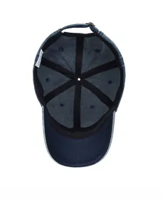 Interior detail of vintage denim baseball cap with reinforcement tape and metal buckle