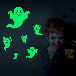 Luminous Halloween ghost wall decals glowing green on dark background with child model