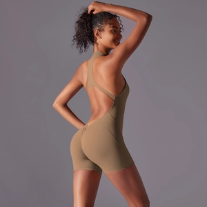 Detail of ruched peach-butt effect and cross-back straps on khaki yoga bodysuit