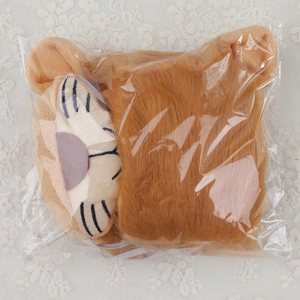 Detail of plush brown lion headband costume accessory for kids packaged in clear bag