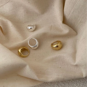 S925 sterling silver star engraved hoop earrings in gold and silver on linen fabric