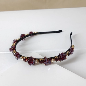 Close-up of luxury crystal headband with red gemstones and sparkling rhinestones
