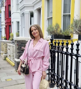 Detail of pink long-sleeve leisure set featuring a lapel collar and waist tie detail
