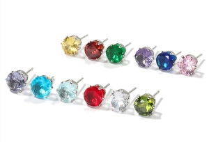 Close-up of six-claw set cubic zirconia stud earrings in a variety of vibrant colors