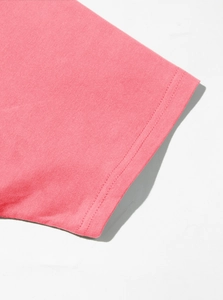 Close-up of pink cotton T-shirt sleeve showing premium double-stitched sewing detail