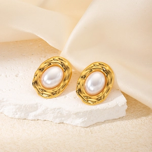 French vintage oval gold earrings with white pearl-like inlay on textured stone