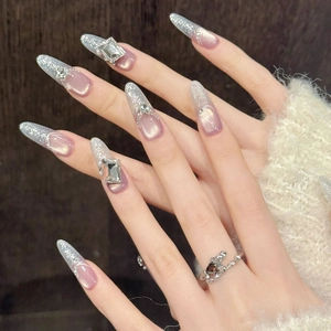 Purple cat eye almond press-on nails with silver glitter and rhinestone accents