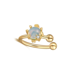 Detailed macro view of gold ear cuff with blue opal stone and small round zircon accent