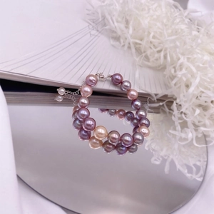 Macro view of double-layer necklace with multicolor baroque pearls and silver clasp