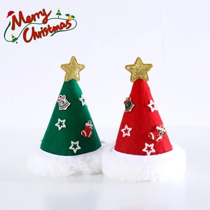Detail of red and green felt pet Christmas hats with plush trim and gold star toppers