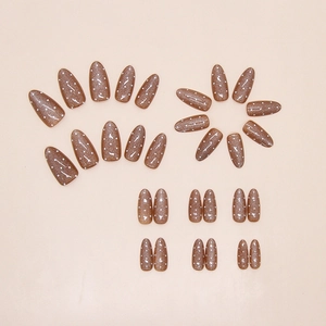 Detailed view of caramel cat-eye press-on nails with white polka dots on beige background