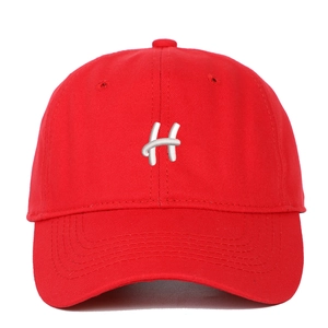 Close-up of a vibrant red baseball cap featuring detailed white embroidered H letter