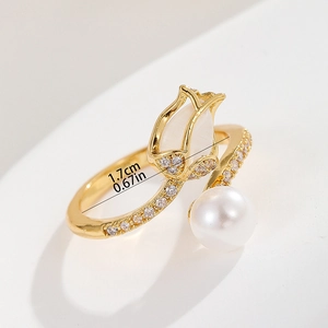 Detail showing 1.7cm inner diameter of gold tulip ring with zircon and pearl accents