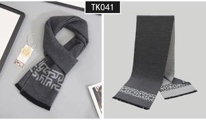 Detail of wool-feel grey scarf with Greek key pattern and soft fringe edges