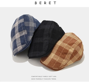 Close-up of vintage plaid beret hats in blue black and brown corduroy fabric