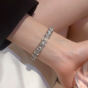 Close-up of sparkling silver stretch bracelet featuring round-cut crystals in a bezel setting