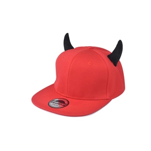 Detailed view of red snapback hat with black devil horns and silver sport cap sticker