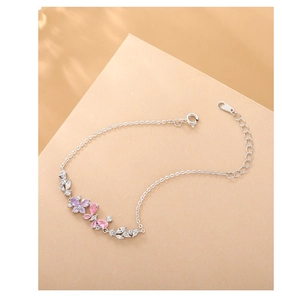 Detail view of silver butterfly bracelet with pink and purple zircon stones