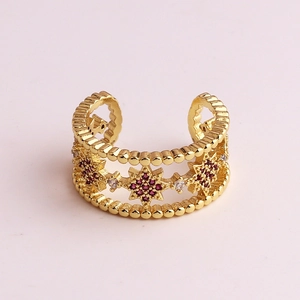 Golden micro-pave zircon open ring with purple starburst centerpiece and wave edge