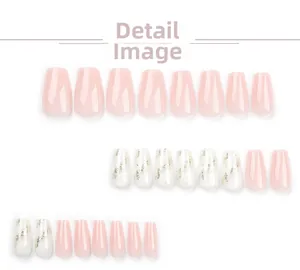 Detail view of pink ballet press-on nails with white marble pattern and gold foil accents