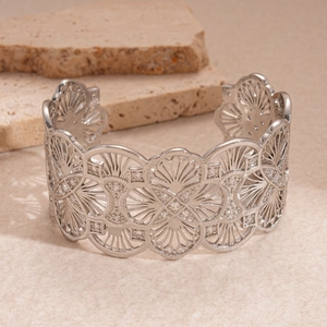 Detailed macro view of silver hollow flower bracelet with sparkling crystals and metal texture