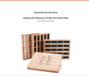 Detail of wooden jewelry trays with colorful velvet slots for ring display