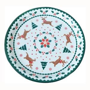 Ceramic Christmas dinner plate featuring reindeer and holiday tree patterns on white background