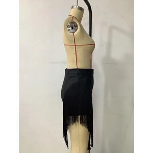 Detail view of black high-waisted mini skirt with long layered fringe tassels for women