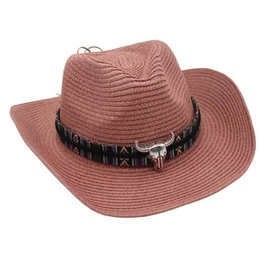 Detail of western straw hat featuring ethnic woven band and silver longhorn skull ornament