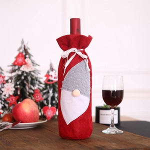Detailed view of Christmas gnome wine bottle cover in festive red and grey knit fabric