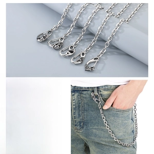 Detailed view of silver titanium steel pants chain featuring a metal skull clasp accessory