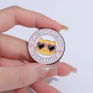 Cartoon enamel badge featuring a cat in heart sunglasses with Meow Meow Catitude text