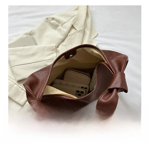 Brown leather hobo bag interior with magnetic clasp and spacious storage for smartphones